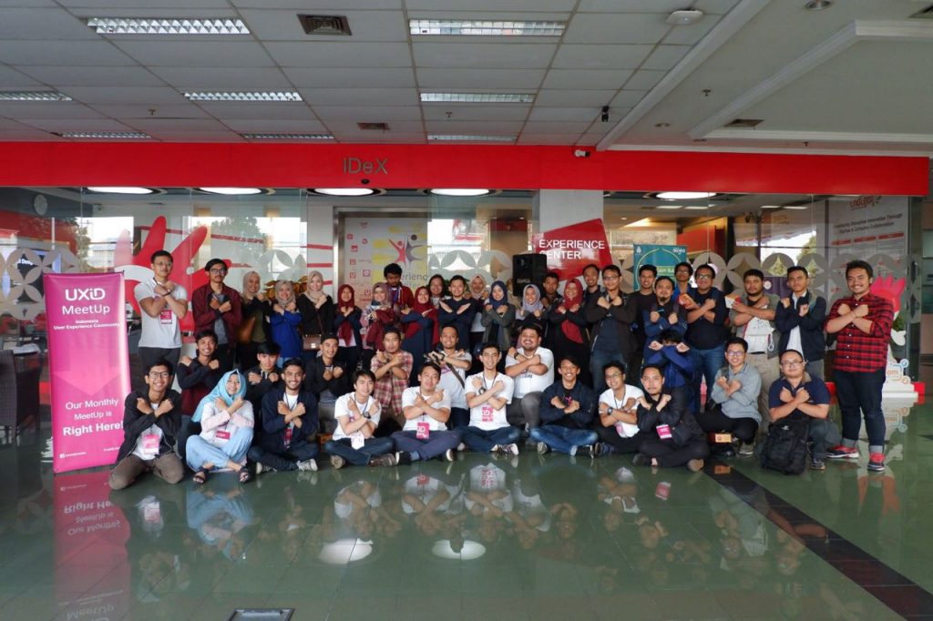 A group of indonesian people making hand gesture of the letter X