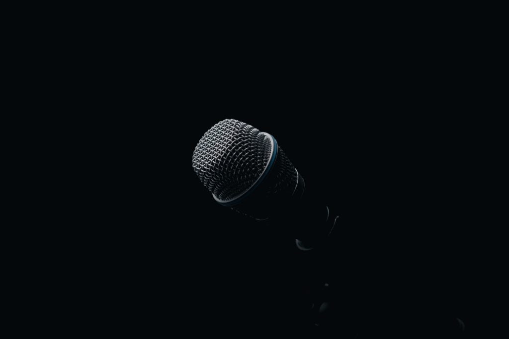 Black-microphone-faded-on-a-black-background